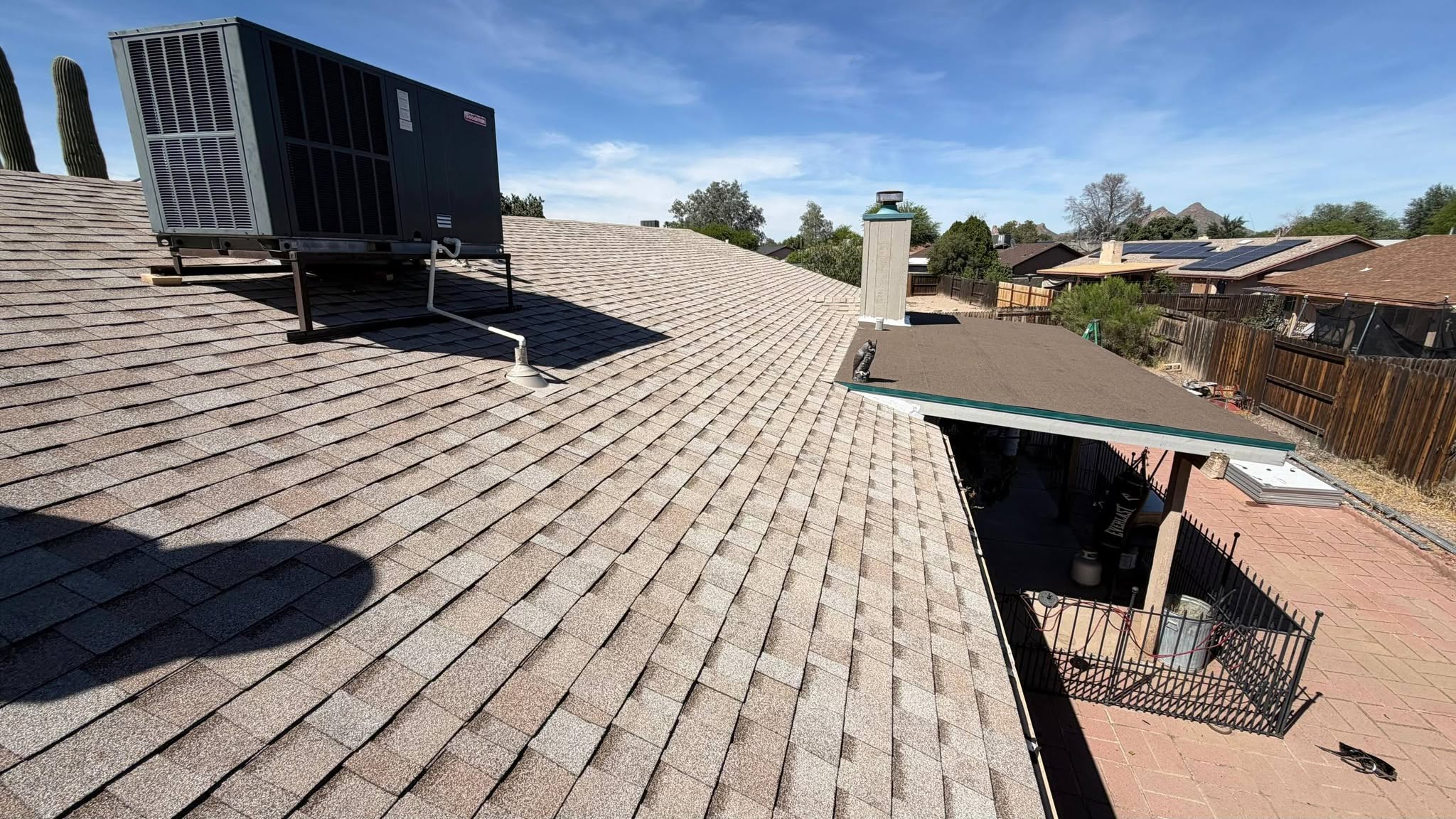 Gray shingle roof around rooftop air-conditioning equipment.