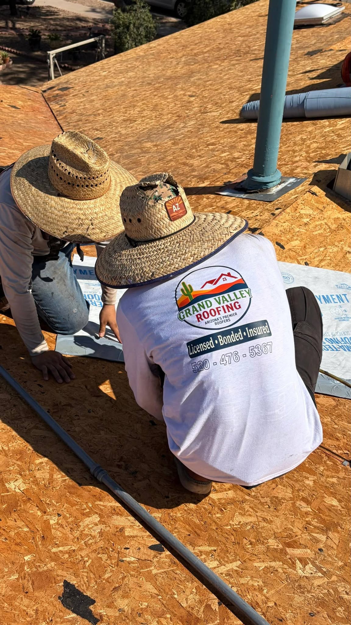 Grand Valley Roofing crew preparing roofing underlayment around roof details.