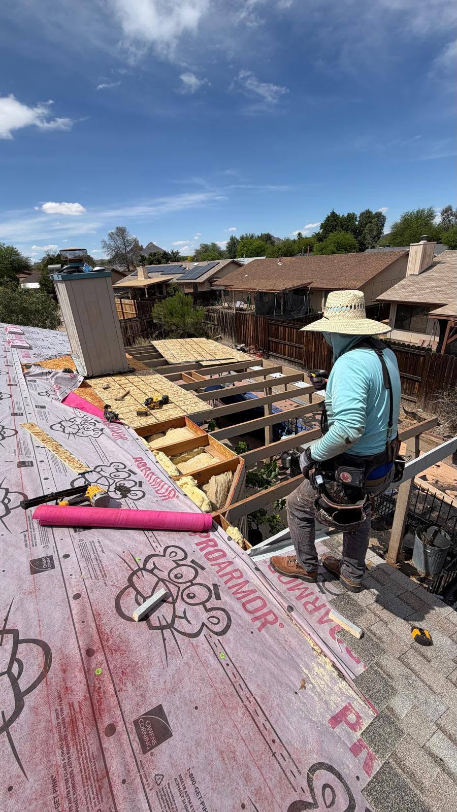Roof framing and underlayment work during a reroof.